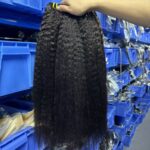 Three bundles of 100% virgin yaki straight weave held in warehouse showing natural yaki texture