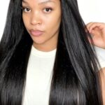 Woman wearing kinky straight bundles installed for a sleek natural hair look