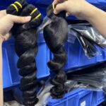 Virgin wholesale loose wave hair bundles close up, defined loose curl pattern, natural black raw human hair wefts