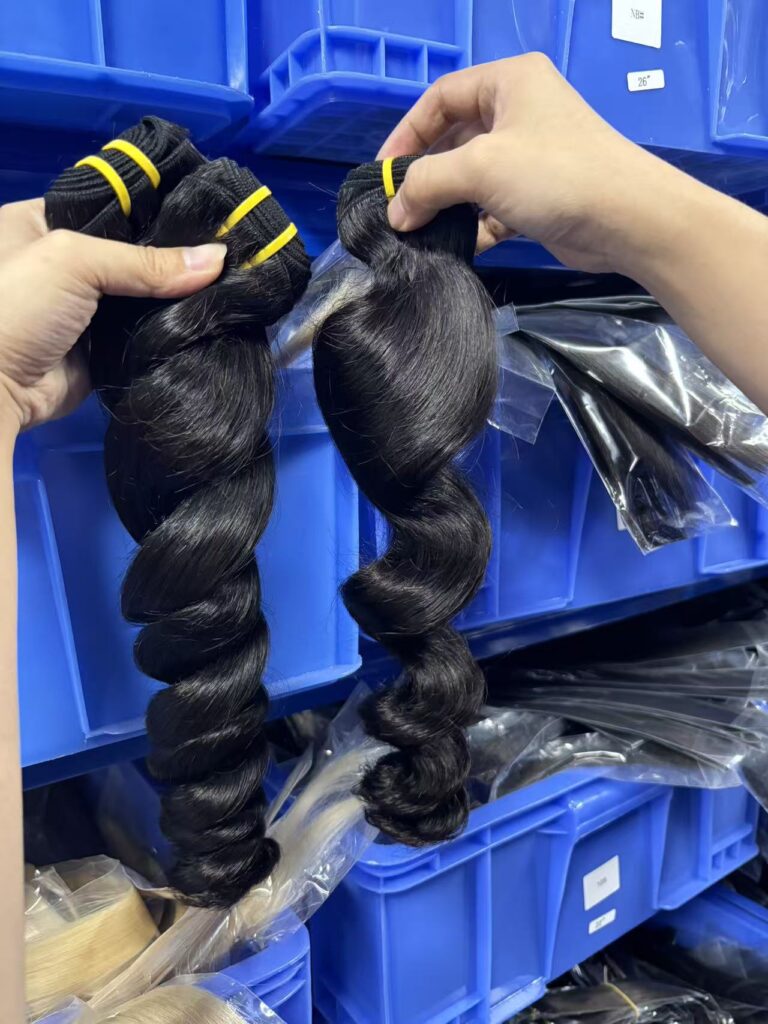 Virgin wholesale loose wave hair bundles close up, defined loose curl pattern, natural black raw human hair wefts